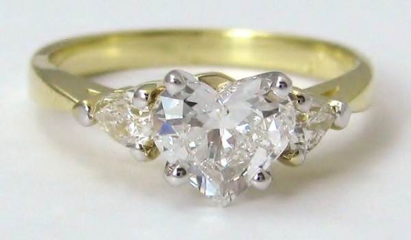 three-stone engagement ring with yellow gold band